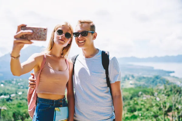 Young Female Male Tourists Standing Hill Green Valley Taking Selfie — стоковое фото