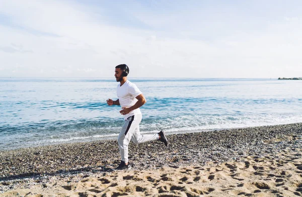 Spor Giyimli Kumsalda Koşan Plajda Antrenman Yaparken Müzik Dinleyen Düşünceli — Stok fotoğraf