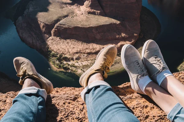 High Angle Anonymous Couple Sneakers Sitting Rocky Cliff Colorado River — Fotografia de Stock