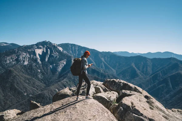 Side View Traveler Backpack Standing Mountain Peak Browsing Smartphone Mountainous — Fotografia de Stock