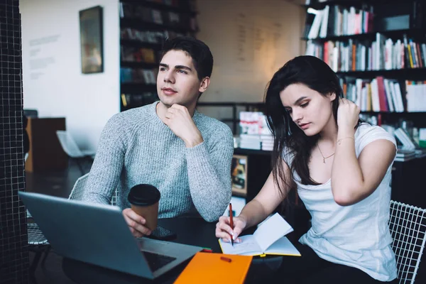 Concentrated Young Female Employee Taking Notes Copybook While Sitting Table — Stock Photo, Image