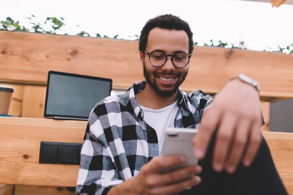 Smiling Male Blogger Classic Eyeglasses Using Cellular Gadget Online Browsing — Zdjęcie stockowe