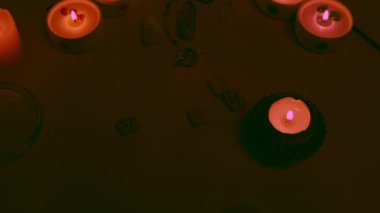 Mystic esoteric ceremony with candles, crystals, runes and quartz pendulum.