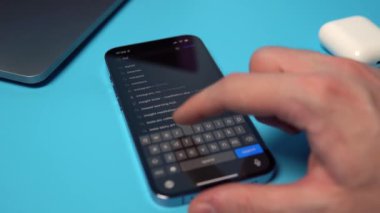 Searching for and downloading Instagram from the App Store on an iPhone. Downloading an application on a phone on a blue background. Mykolaiv, Ukraine, July 06 2022. 