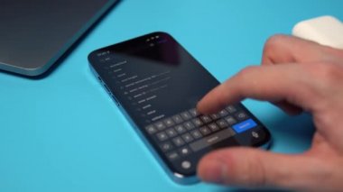 App Store 'dan bir iPhone' a Ses Bulutu aranıyor ve indiriliyor. Mavi arkaplandaki bir telefona bir uygulama indiriliyor. Mykolaiv, Ukrayna, Temmuz 06 2022. 