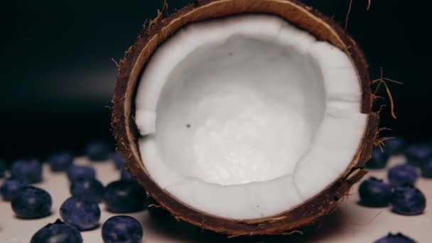 Two Halves Coconut White Pulp Handful Blueberry Rotation — ストック動画