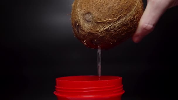 Pouring Coconut Water Red Cup Black Background — Videoclip de stoc
