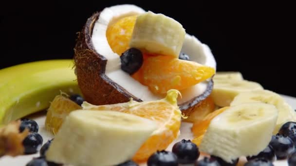 Banana Pieces Tangerine Slices Berries Half Coconut Fruits White Surface — Stockvideo