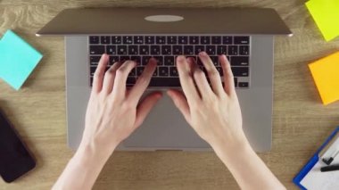 Hands on laptop, working concept, post it papers and coffe cup on desk, freelance. High quality FullHD footage