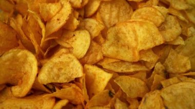 Potato chips close-up, hand takes snacks. Eating fast food. High quality 4k footage