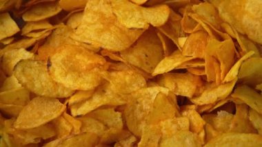 Potato chips close-up, hand takes snacks. Eating fast food. High quality 4k footage