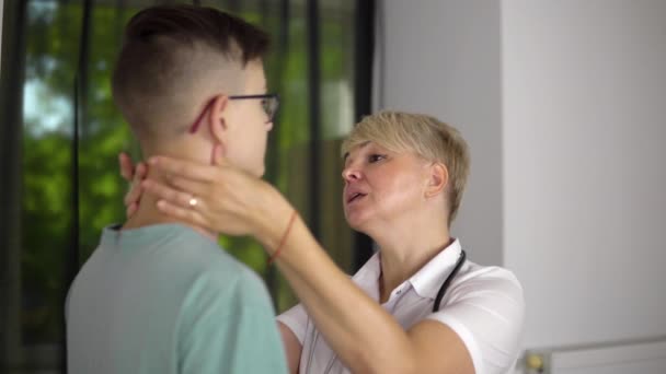 Adult Woman Doctor Checking Lymph Nodes Young Boy Clinic Appointment — Video