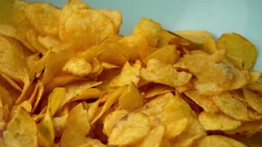 Potato chips close-up, hand takes snacks. Eating fast food. High quality 4k footage