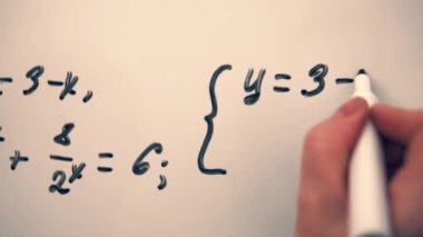 Mathematics equation on whiteboard. Math algebra lessons, education concept. Writing equation close up.