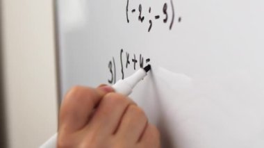 Mathematics equation on whiteboard. Math algebra lessons, education concept. Writing equation close up.