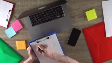 The student is learning the programming course and making notes. Education concept. Comfortable workplace.