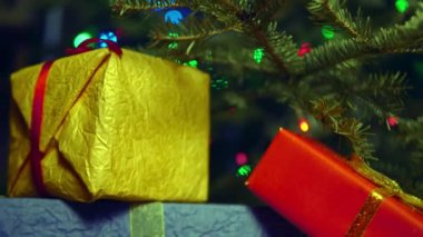 A bunch of gifts in corrugated colorful gift wrap for Christmas close up.
