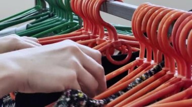 Girl chooses underwear in the store. Clothes on plastic hangers. High quality 4k footage