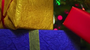 Presents under Christmas tree to New Year. Colorful gift wraps.