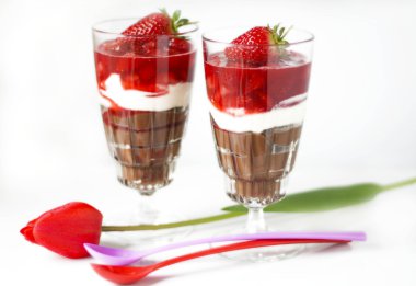 Soft cheese and strawberry dessert in glasses clipart