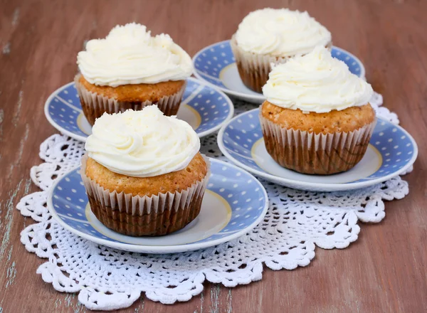 Coconut cupcakes on saucers — Stock Photo, Image