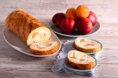 Swiss roll with cream and fruit filling, sliced and served