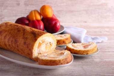Swiss roll with cream and fruit filling, sliced and served