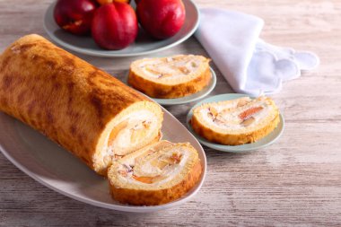 Swiss roll with cream and fruit filling, sliced and served