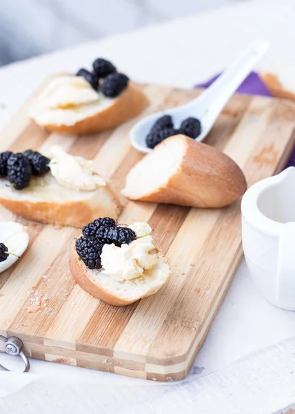 Snack on french baguette on a wooden board — Stock Photo, Image