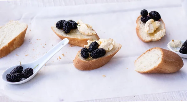 Snack on french baguette on a wooden board — Stock Photo, Image