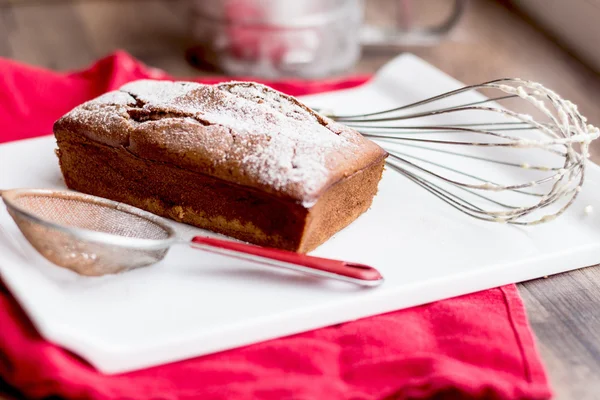 Chocolate cake, whisk, strainer — Stock Photo, Image