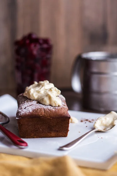 Čokoládový dort se smetanovým krémem, syrové cherry na bílé plotně — Stock fotografie