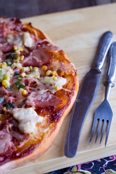 Pizza  on a plate, white table and a cutlery — Stock Photo, Image