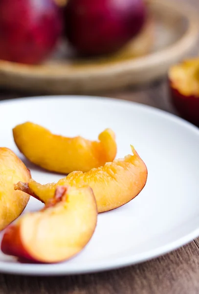 bright peach slices on white round plate