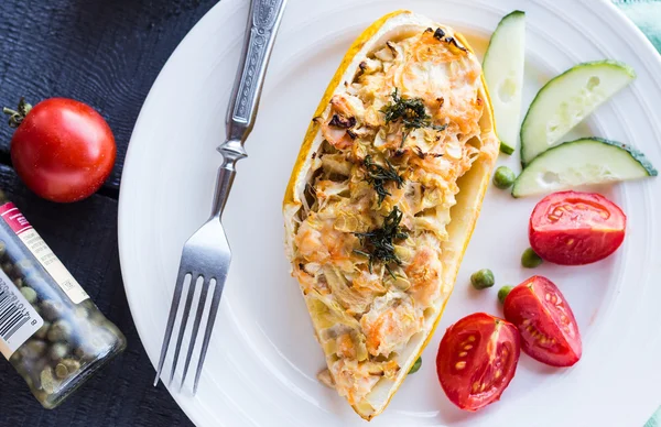 Warm stuffed zucchini with chicken and vegetables on a white pla — Stock Photo, Image