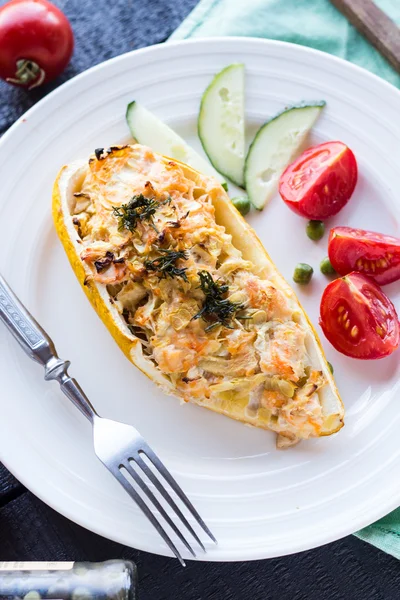 Warm stuffed zucchini with chicken and vegetables on a white pla — Stock Photo, Image