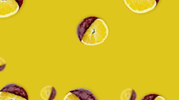 Orange Slices Chocolate Different Diameters Floating Warm Yellow Background Animation — Stock Video