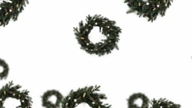 Beyaz bir arka planda farklı çaplarda Noel yeşili ladin çelengi. 4K UHD görüntüsü. Geleceksel tasarım, hareket tasarımı animasyonu. Pop sanat tasarımı, yaratıcı Noel tatlısı yemek konsepti.