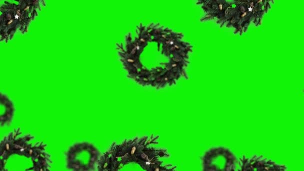 Летающий Сельский Рождественский Венок Разных Диаметров Висит Зеленом Экране Изолированном — стоковое видео