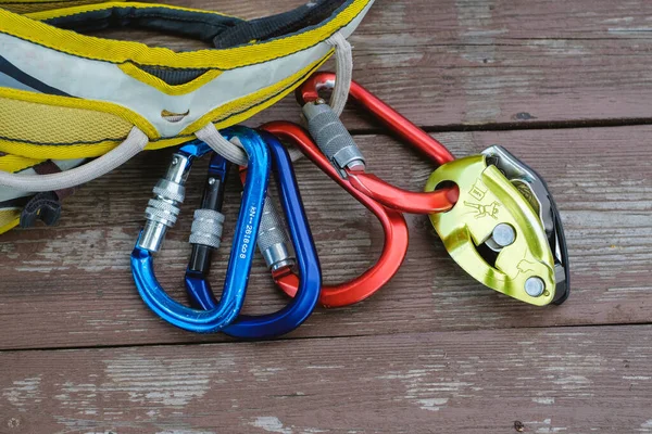 Climbing and mountaineering equipment on wooden background. top view