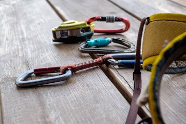 Climbing and mountaineering equipment on wooden background