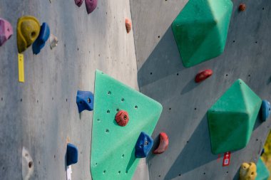 climbing stand simulator outdoors. Artificial holds for training rock climbers. Summer evening light