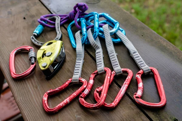 Climbing and mountaineering equipment on wooden background