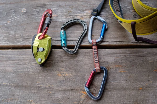 Climbing and mountaineering equipment on wooden background