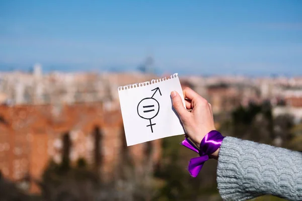 一个年轻的高加索女人的衣服 上面有一张纸 上面画着两性平等的符号 — 图库照片