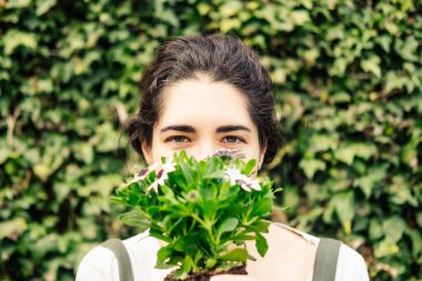 Close-up of a young woman holding some daisies. Nature concept.