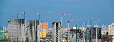 Kyiv, Ukraine April 7, 2022: tower construction cranes on the construction of high-rise buildings