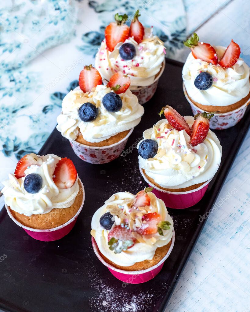 Muffins with strawberries in baking dish. top view