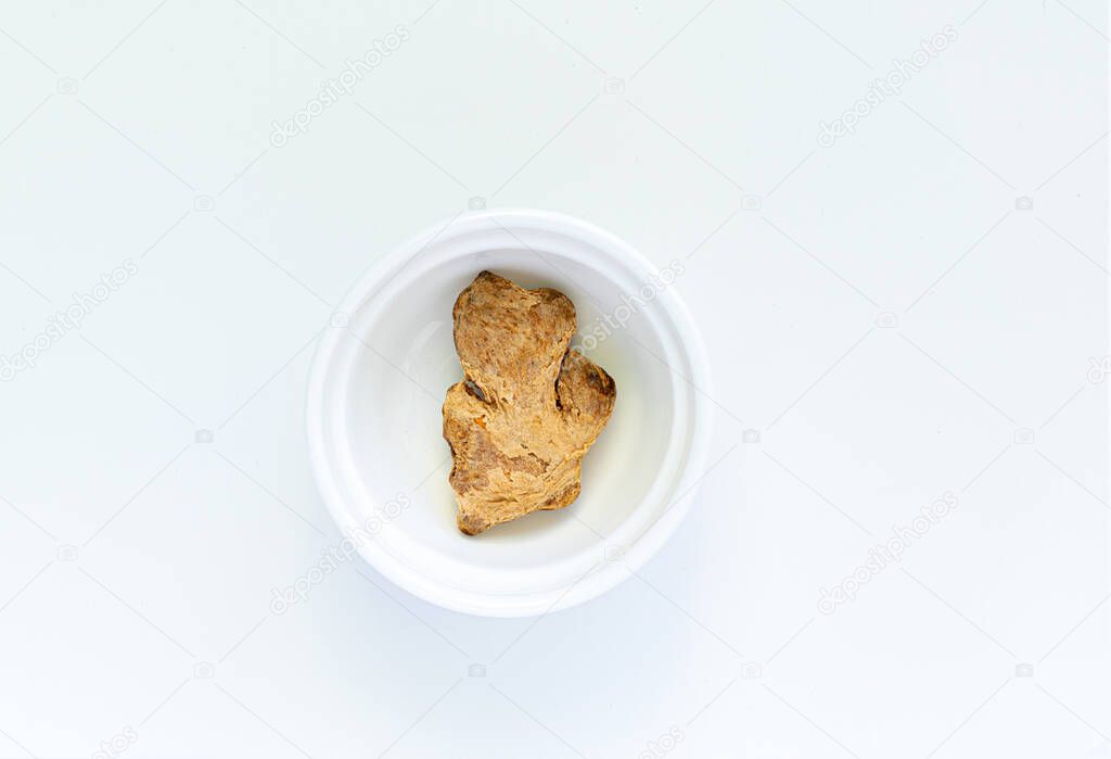 ginger on a white plate, on a white background