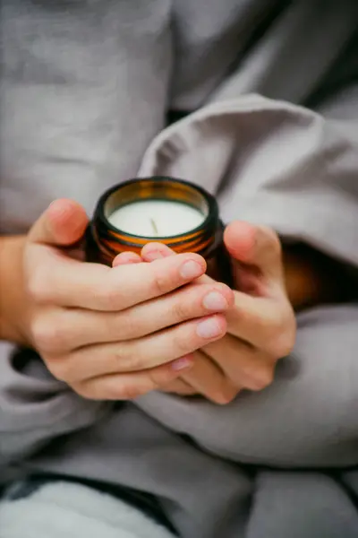 candle in hands close-up